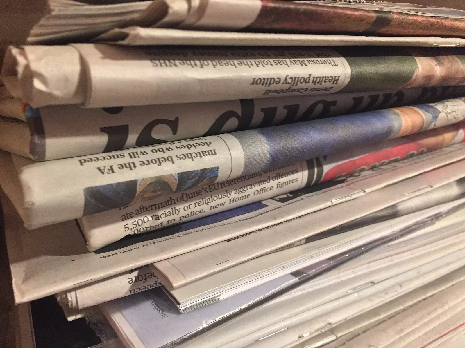 A pile of folded newspapers.